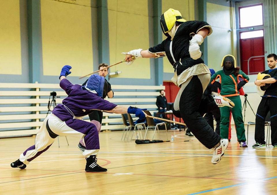 A Canne Klub Kamnik member scoring a hit against his opponent while jumping to avoid an attack